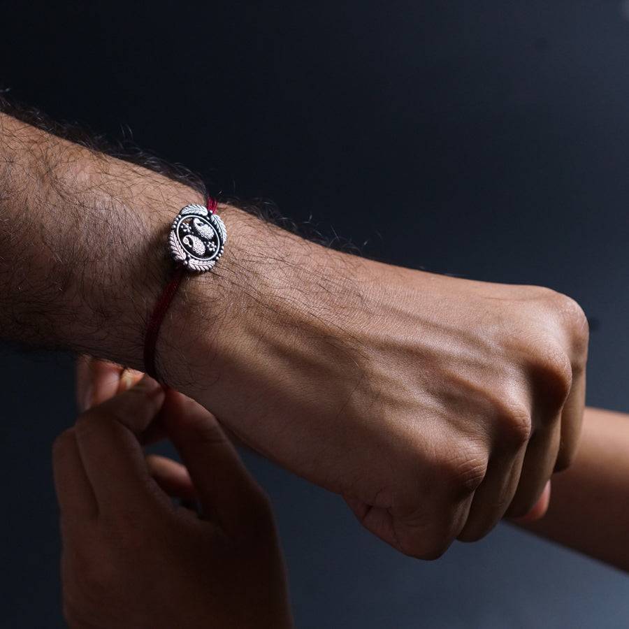 a man holding a woman's hand with a bracelet on it