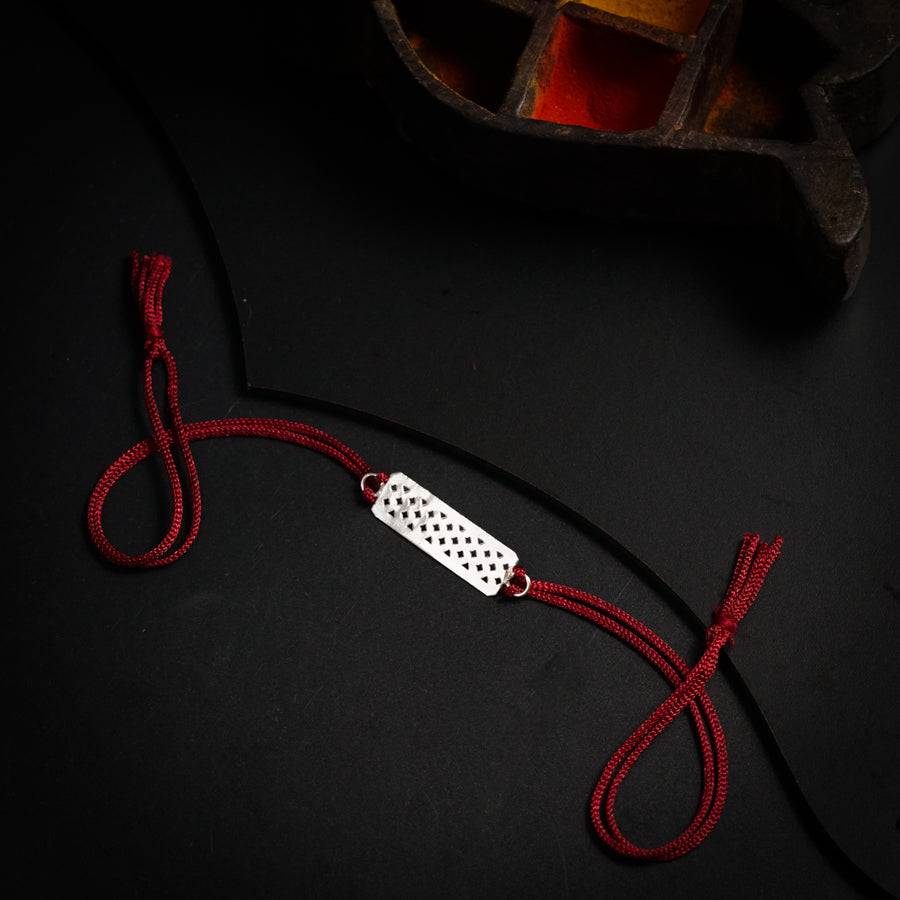 a red string with a white object on it