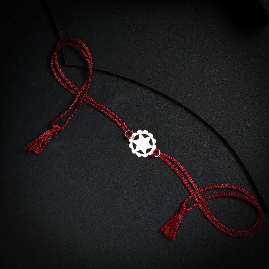 a red rope with a white bead on it