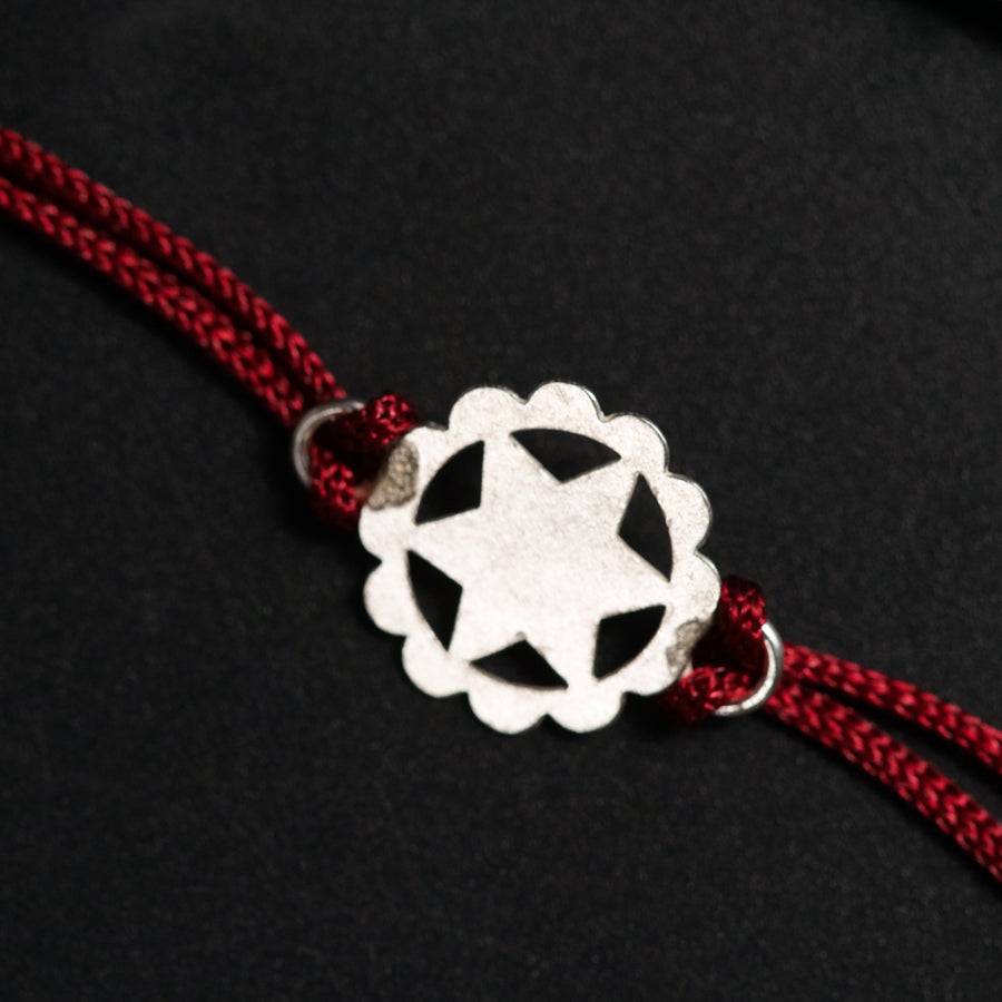 a red cord with a silver star on it