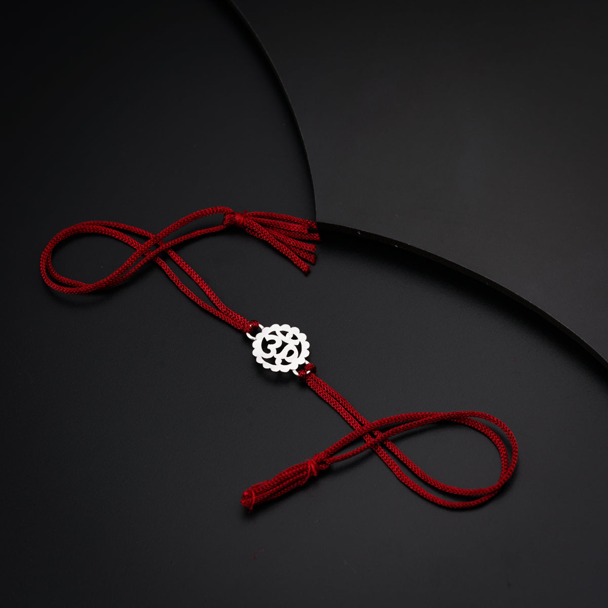 a red cord with a white bead on it