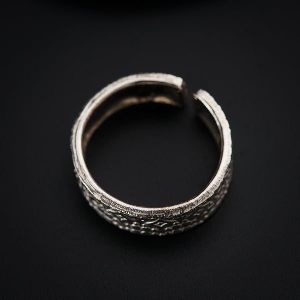 a close up of a ring on a black surface
