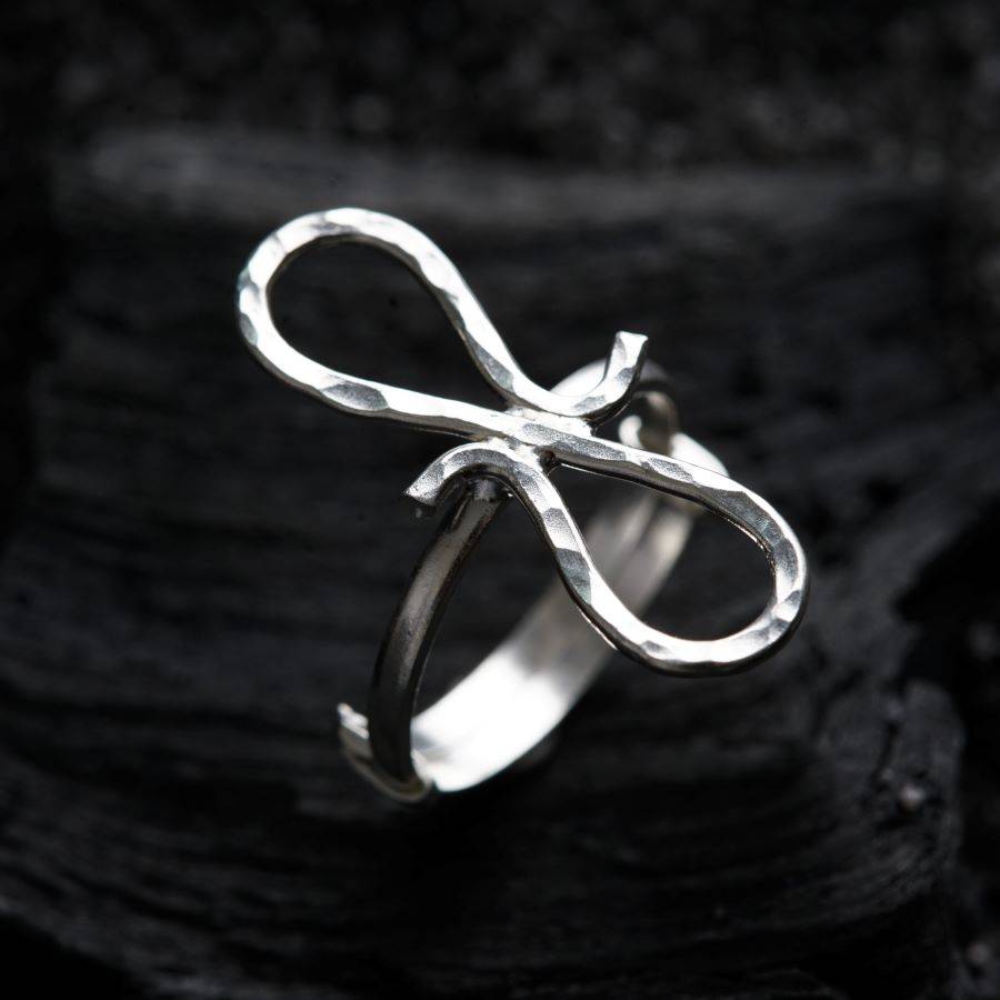 a close up of a silver ring on a black surface