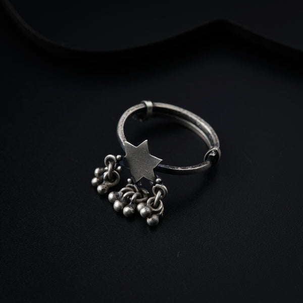 a silver ring with a star on top of it