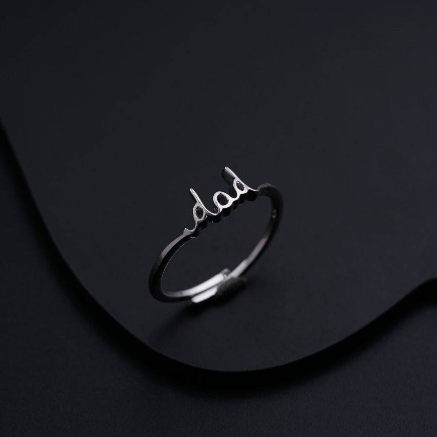 a silver ring with the word baby written on it