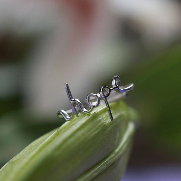 a close up of the word hope on a leaf