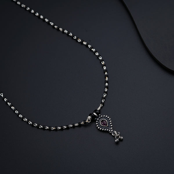 a necklace with a heart and a cross on it