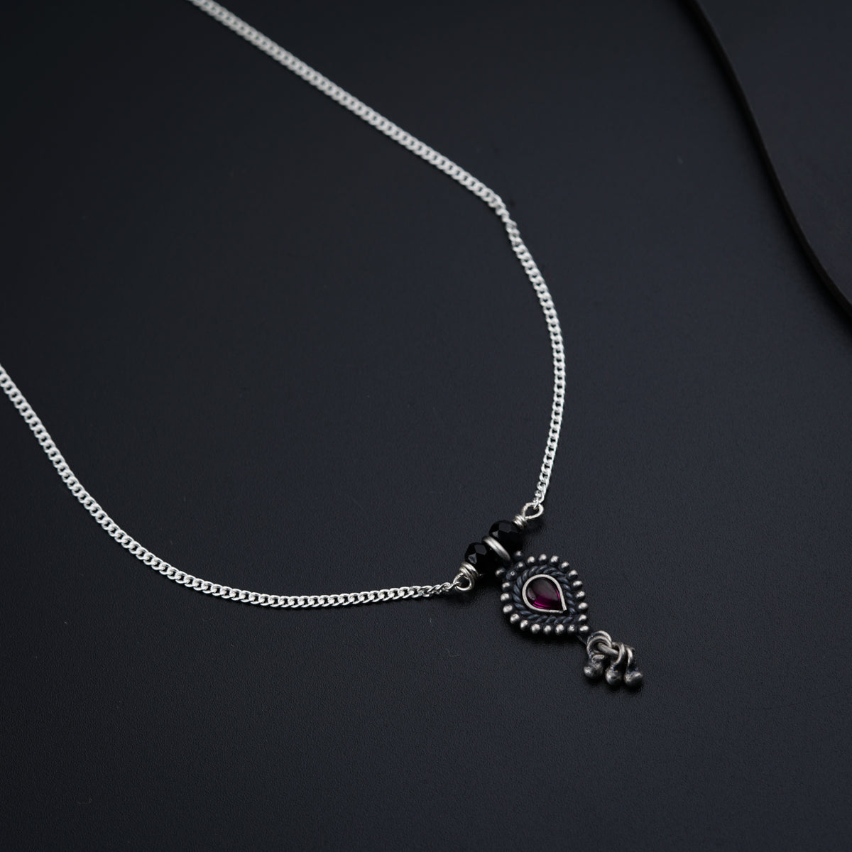 a necklace with a heart and a cross on it