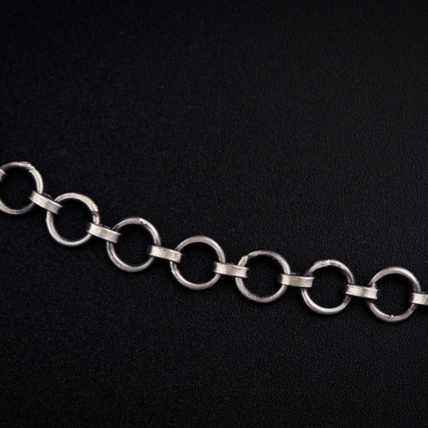 a silver chain on a black background