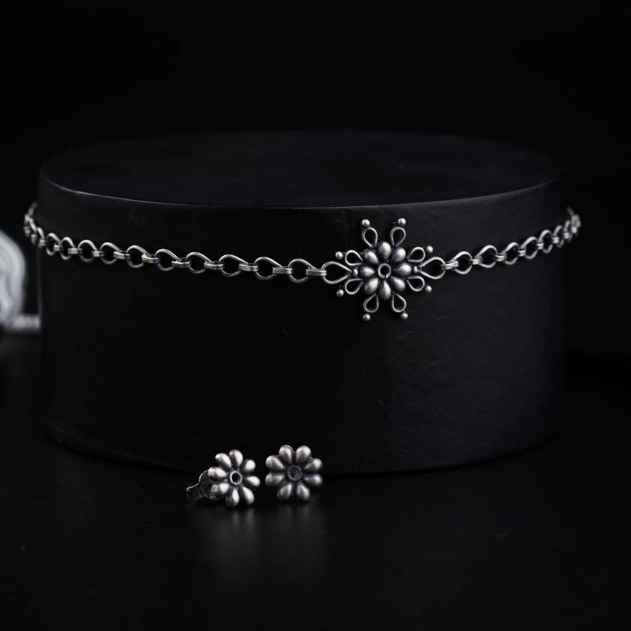 a close up of a black hat with a chain around it