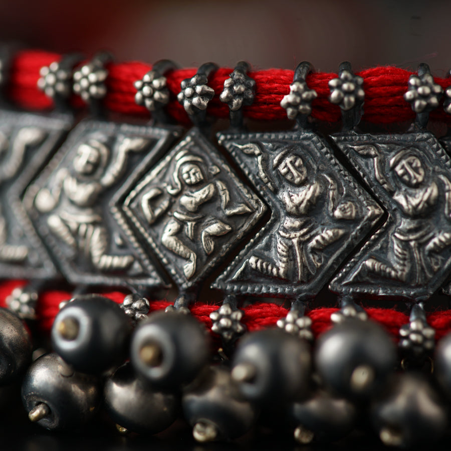 a close up of a bracelet with metal beads