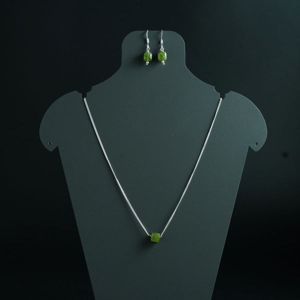 a necklace and earring set with green beads