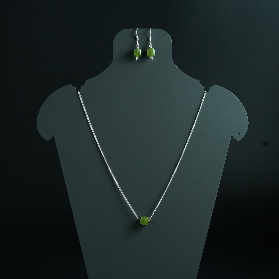 a necklace and earring set with green beads