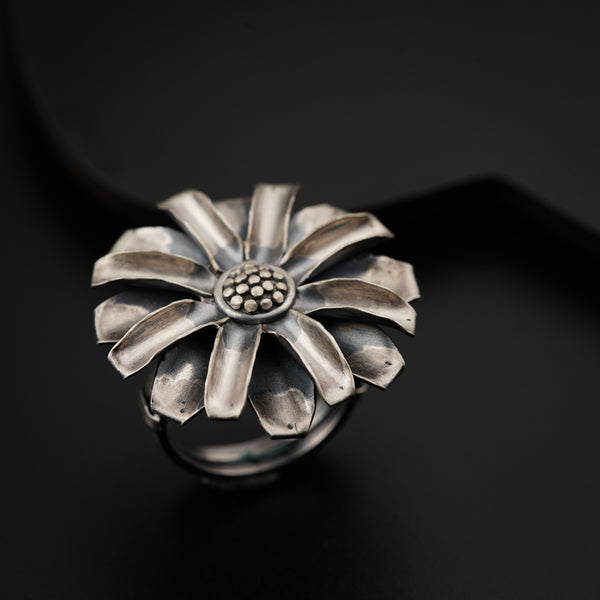 a silver ring with a flower design on it