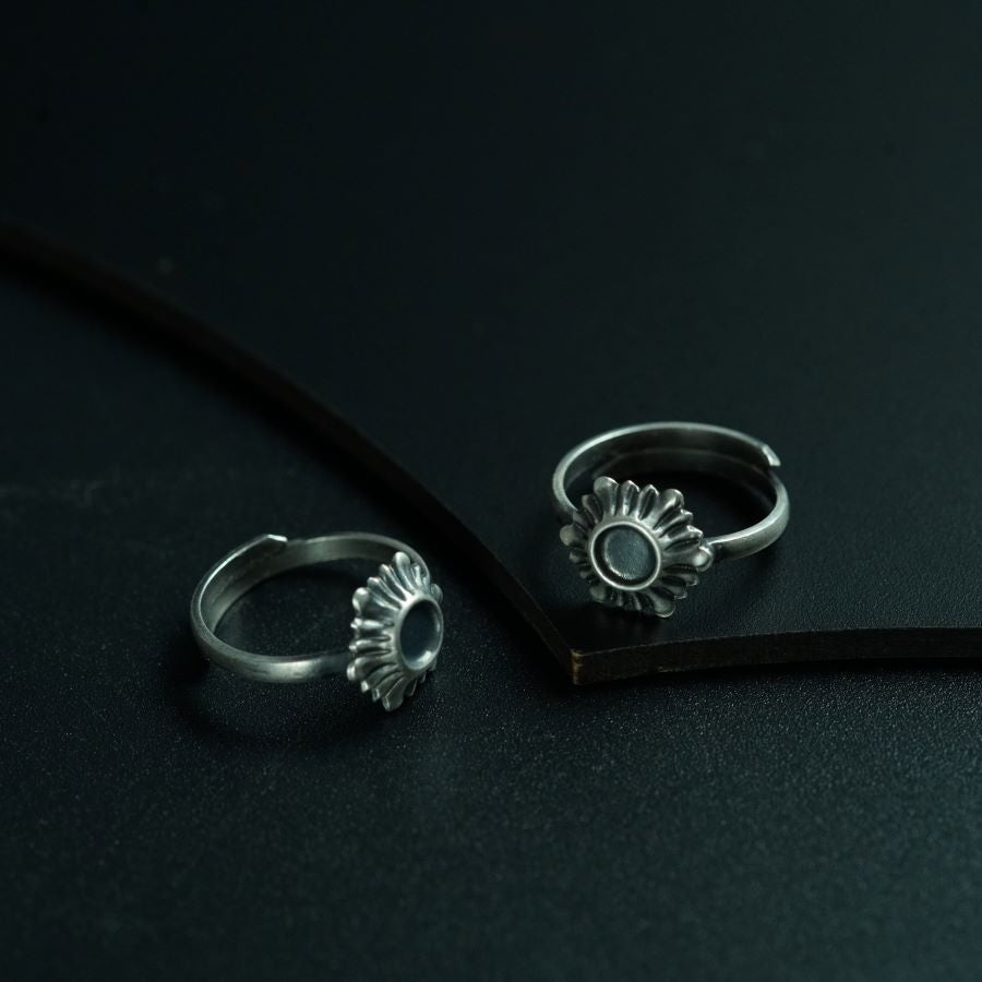 a pair of rings sitting on top of a black surface