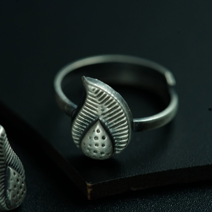 a pair of silver rings sitting on top of a book