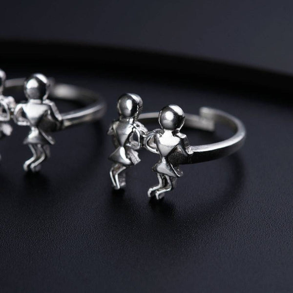 a couple of silver rings sitting on top of a table