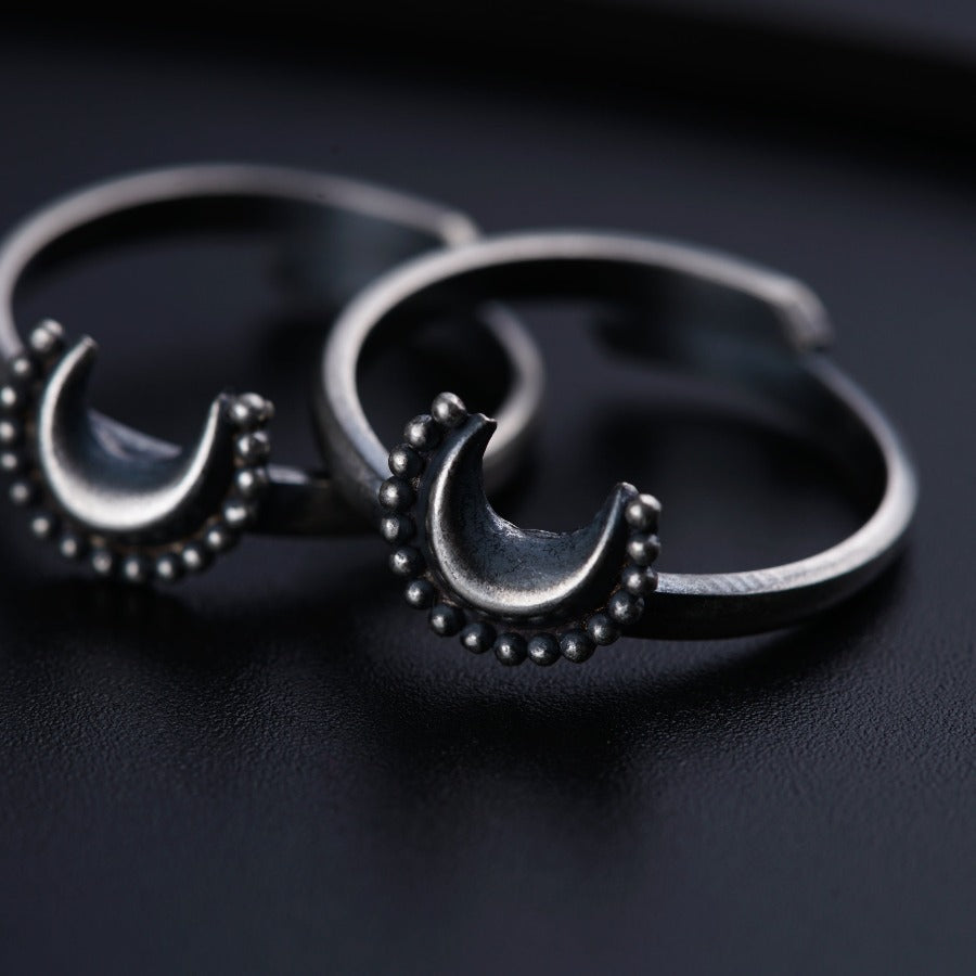 a pair of silver hoop earrings sitting on top of a table