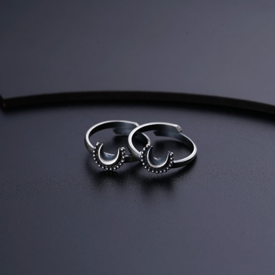 a pair of silver rings sitting on top of a table