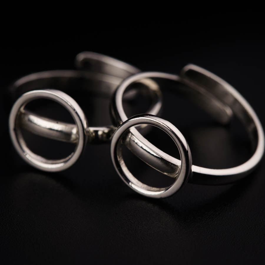 a close up of three rings on a black surface