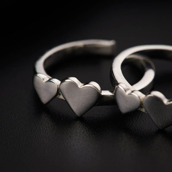 a couple of silver rings sitting on top of a table