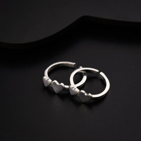 a pair of silver rings on a black surface