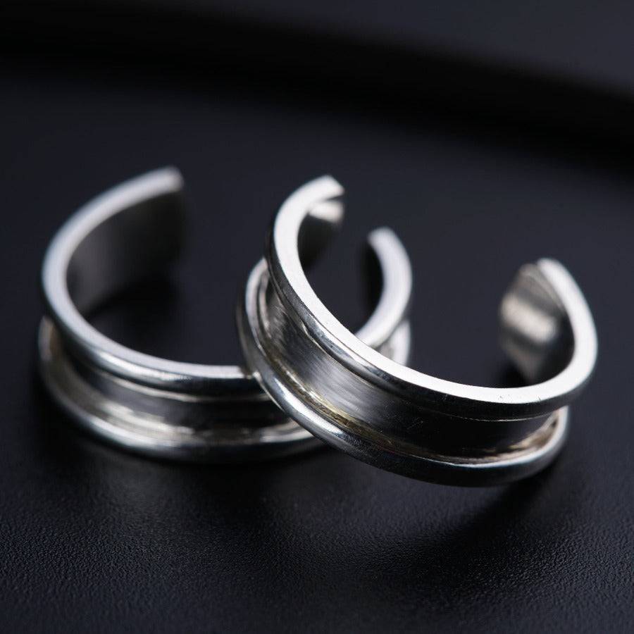 a couple of silver rings sitting on top of a table