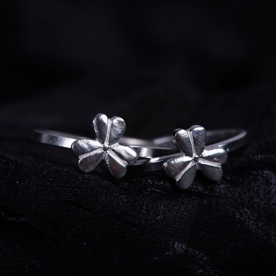 a close up of two silver rings on a black surface